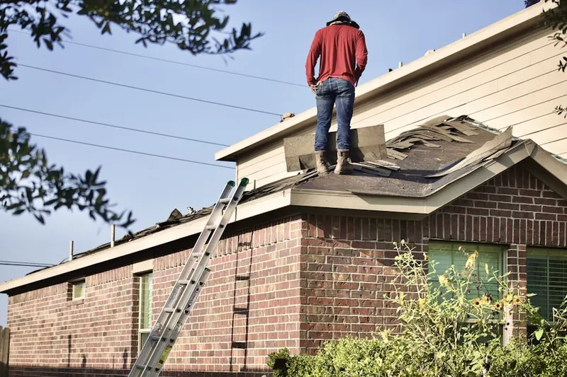Professional roofer working on a residential roof in St. Marks